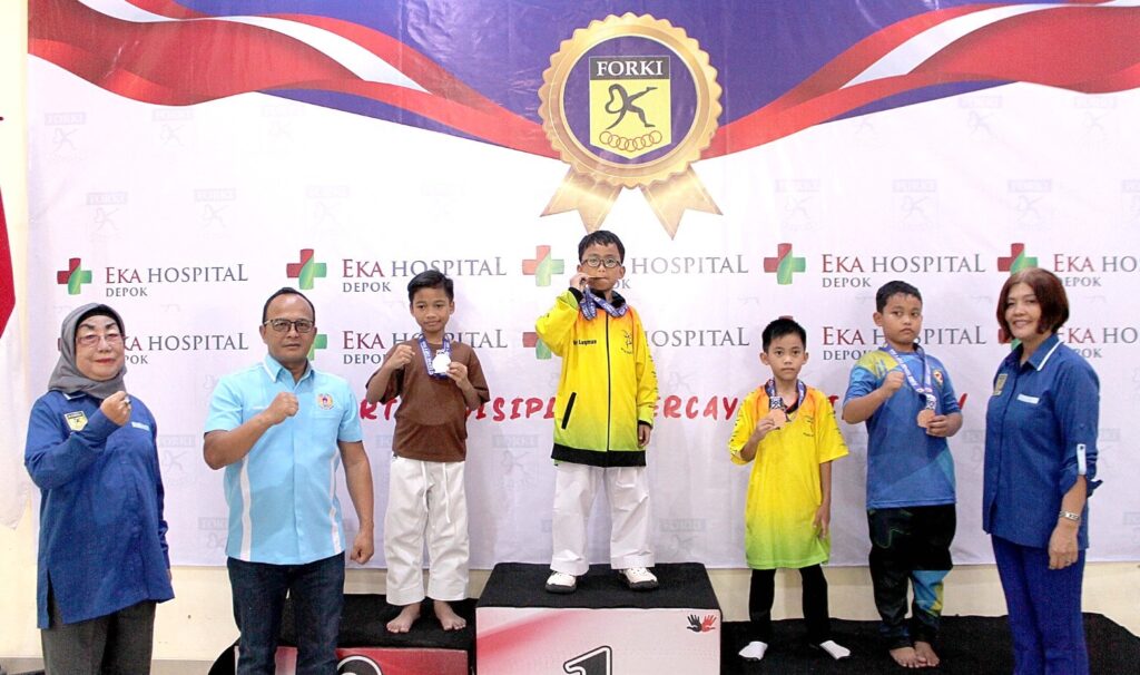 Wakil Ketua KONI Depok, Hendra Dimun, foto bersama karateka cilik yang menjuarai kejuaraan karate FORKI Depok Cup V di Balai Rakyat Beji, Kelurahan Beji, Minggu (02/08/2026). (Foto: KONI Depok)